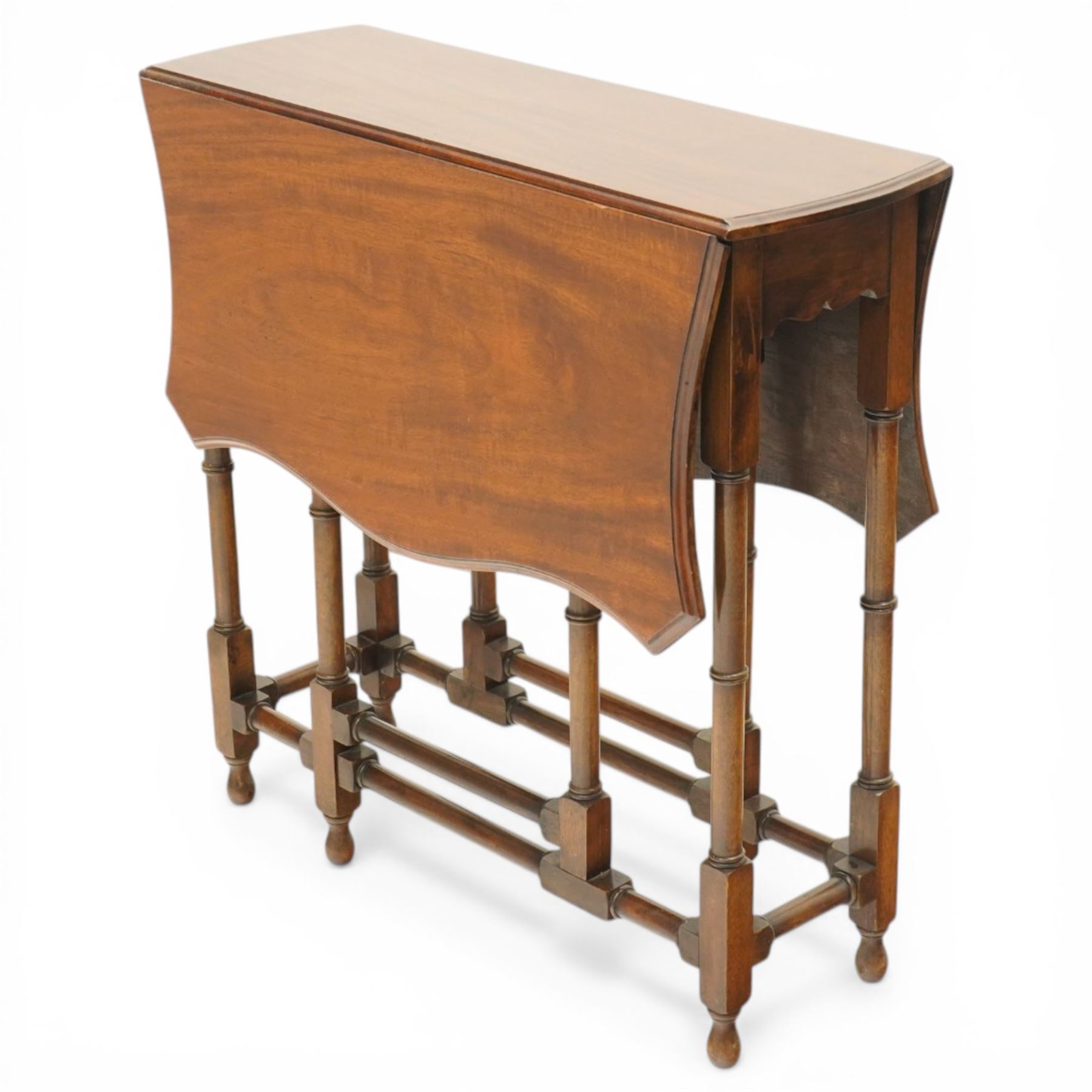 Edwardian mahogany Sutherland table, shaped rectangular drop-leaf top with canted corners and moulded edge, raised on ring-turned gate-leg base united by stretchers