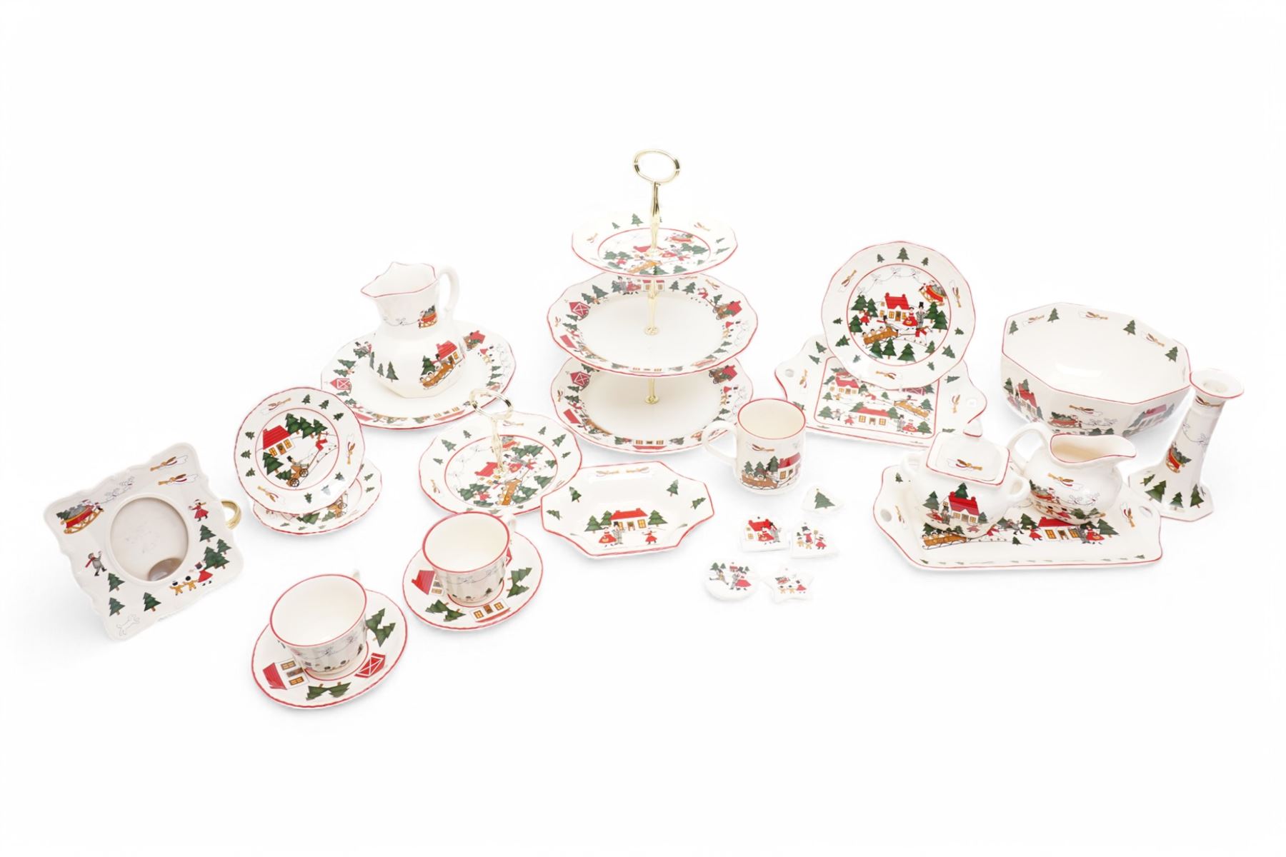 Masons Christmas Village tea wares, designed by Marsten-Mandrajji, comprising three-tiered an other cake stand, large bowl and jug, two twin-handled serving dishes, mug and two teacups, plates of various sizes etc