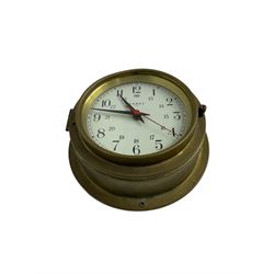 Contemporary quartz timepiece in the style of a ship’s bulkhead clock, with a 5” dial and 9” spun brass case, with a white 24-hour dial, baton hands and seconds sweep hand, dial inscribed “Cooke” Hull.