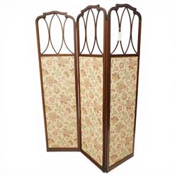 Edwardian inlaid mahogany three-fold screen, each panel with shaped cresting and satinwood line inlaid frame, with intersecting astragal bars, lower panels upholstered in floral fabric, hinged folding action on brass hinges