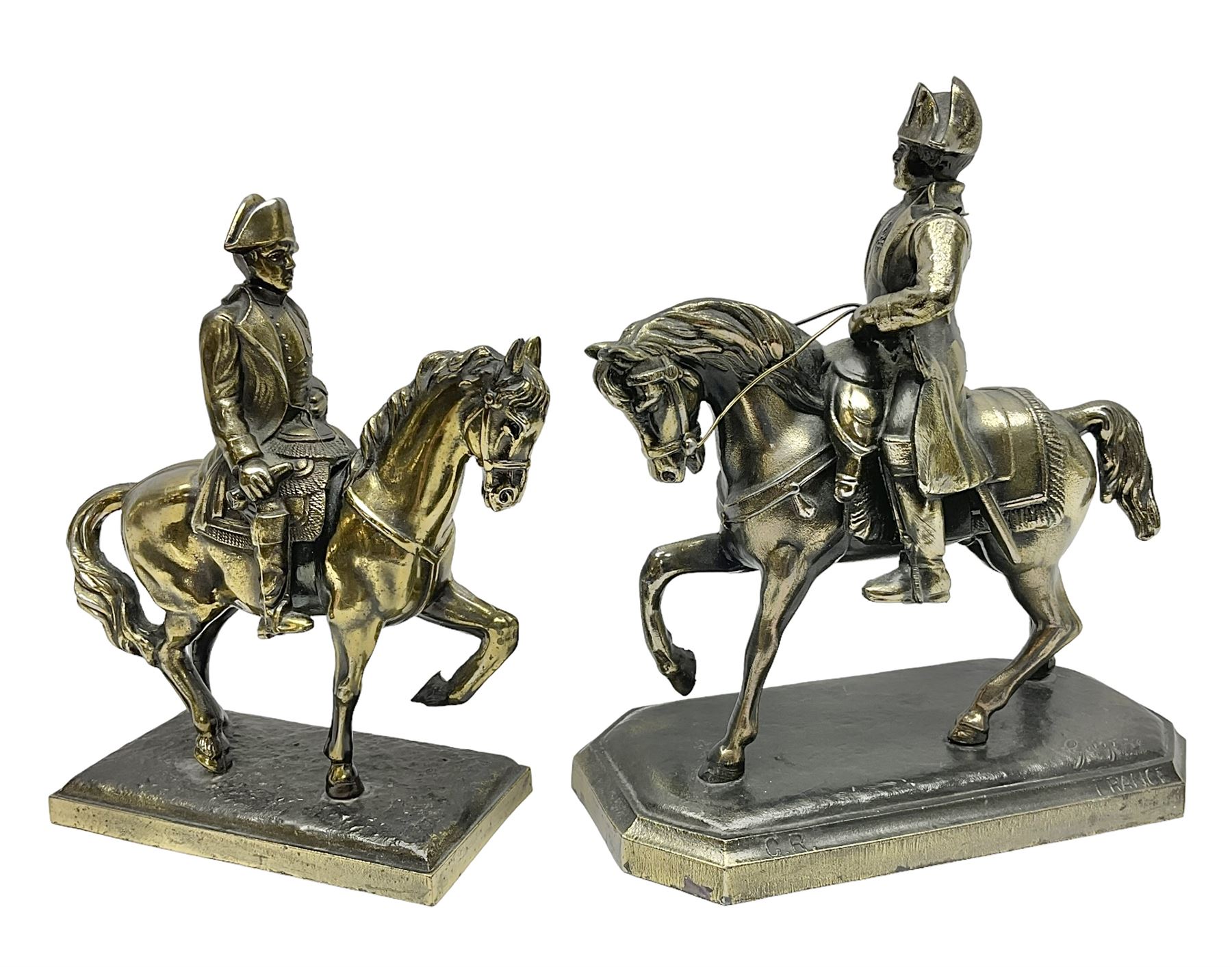 Two figures of Napoleon on horseback, one example standing on octagonal bases marked 'G R France' indistinctly signed, the other on a rectangular base, H19cm 
