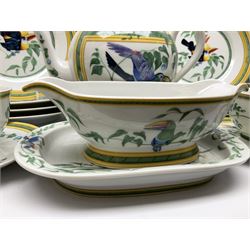 20th century Hermes Paris porcelain dinner and tea service for eight place settings, decorated in the Toucans pattern, comprising dinner plates, salad plates, dessert plates, dishes, tureen and cover, oval platter, shallow bowl, high sided bowl, sauce boat and stand, teapot, teacups and saucers, twin handled sucrier and cover, and milk jug, with green printed marks beneath, with a number of Hermes dust bags