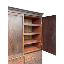 George III mahogany Gentleman's linen press, the projecting cornice over two panelled cupboard doors enclosing three sliding trays, the base fitted with two short over three long graduating cock-beaded drawers, lower moulded edge over bracket feet