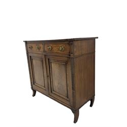 Regency period mahogany side cabinet, rectangular top over two drawers and panelled double cupboard, horizontal and vertical reeded uprights, on splayed sabre feete