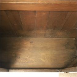 20th century dark stained oak hall robe, cantered sides enclosing a hooks and a shelf, panelled and carved sides, raised on stile supports