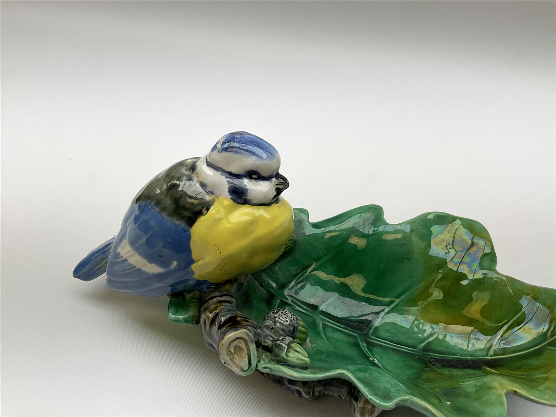 Minton majolica leaf dish, modelled as a Blue Tit perched on a branch with acorns and an oak leaf, date cypher for 1868, impressed marks beneath, L21cm. 