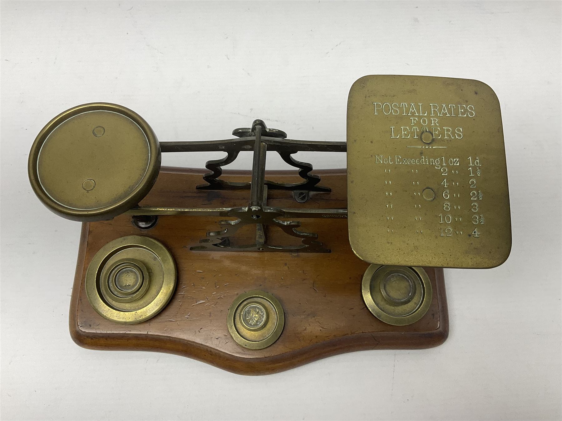 Set of brass postal scales, on wooden base