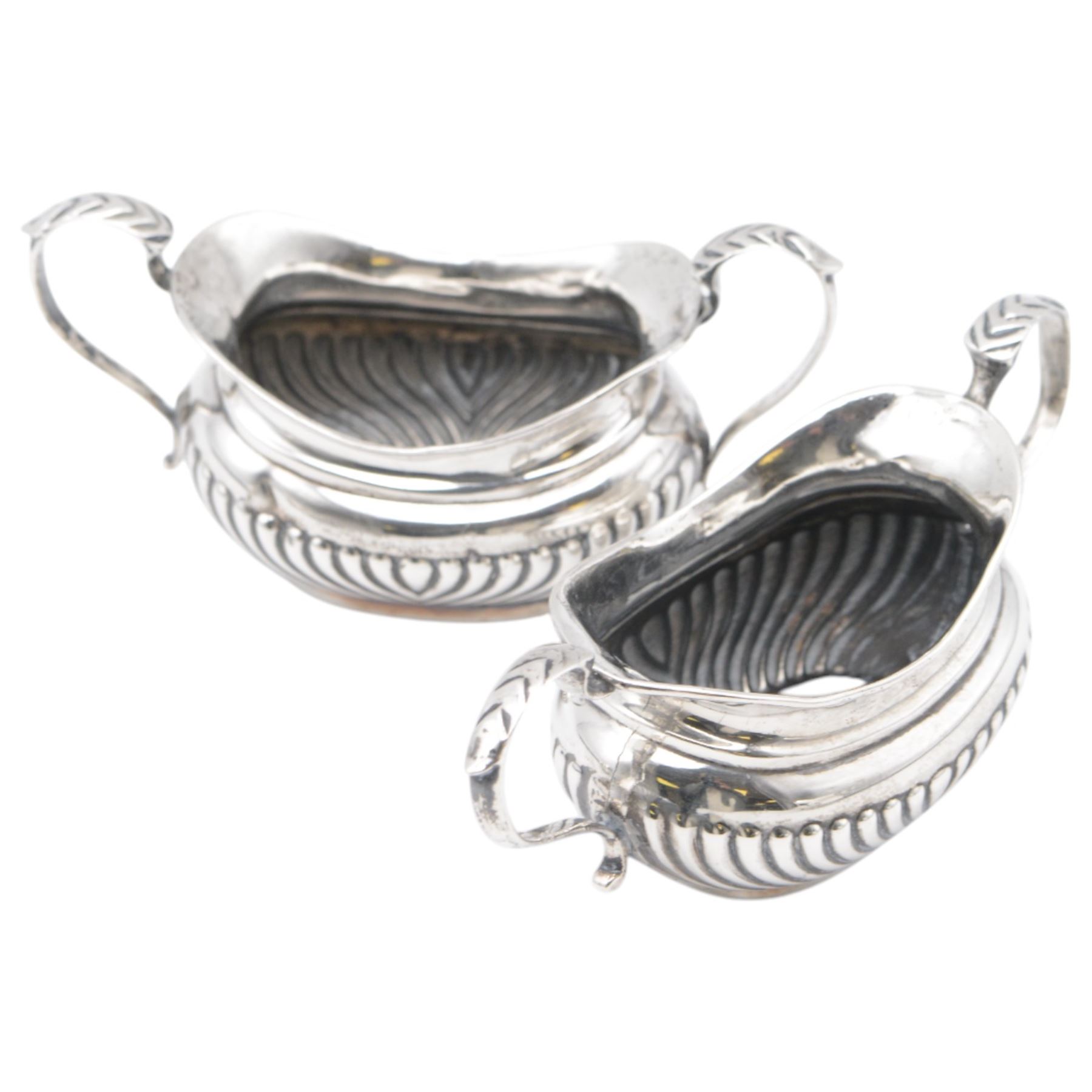 Group of silver, comprising 1930s five bar toast rack, hallmarked B & W Ltd, Birmingham 1931, three piece Edwardian silver cruet set comprising two open salts and a pepper shaker, hallmarked E J Trevitt & Sons, Chester 1904 and a small 1930s silver sauce boat, hallmarked Edward Barnard & Sons Ltd, London 1937 