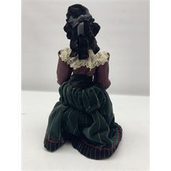 Anna Meszaros Hungary - hand made needlework finely detailed figurine of a pensive old lady seated on a stool wearing a lace trimmed long black and maroon dress and hat, clutching a lace bag H32cm Auctioneer's Note: Anna Meszaros came to England from her native Hungary in 1959 to marry an English businessman she met while demonstrating her art at the 1958 Brussels Exhibition. Shortly before she left for England she was awarded the title of Folk Artist Master by the Hungarian Government. Anna was a gifted painter of mainly portraits and sculptress before starting to make her figurines which are completely hand made and unique, each with a character and expression of its own. The hands, feet and face are sculptured by layering the material and pulling the features into place with needle and thread. She died in Hull in 1998.