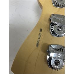 Fender Precision Bass guitar, in Olympic White finish with tortoiseshell effect scratchboard, serial no US15103092, in black Fender hard case with Fender strap and warranty card, guitar L116cm