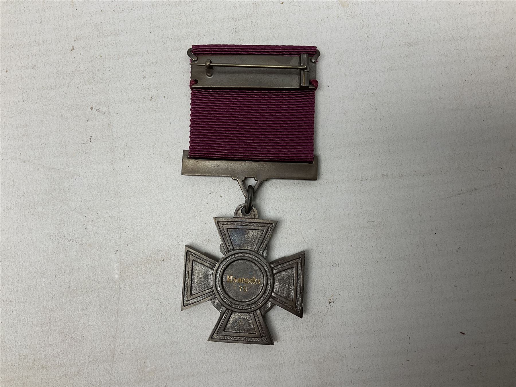 Victoria Cross, an official Hancocks & Co, London replica, the reverse engraved ‘Hancocks 70’, in fitted leather case of issue; Auctioneer's Note: The Victoria Cross was instituted on 29th January 1856, with the first awards backdated to 1854, and in the first 150 years of its existence was awarded on 1,355 occasions (1,352 Crosses and 3 Second Award Bars). To mark the 150th Anniversary, the London jewellers Hancocks, who have manufactured every Victoria Cross ever awarded, issued a limited edition replica, the replicas all individually numbered on the reverse, with the edition limited to 1,352 replica crosses.