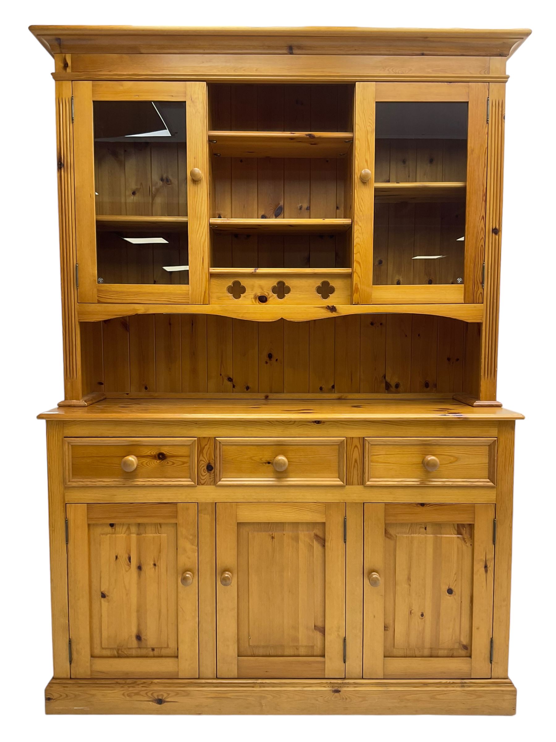 Traditional pine dresser, the rack fitted with two shelves flanked by glazed cupboards, the base with three drawers over three panelled cupboards