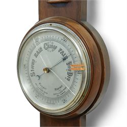 An English 20th century aneroid barometer with a slivered dial and surface mounted mercury thermometer.
