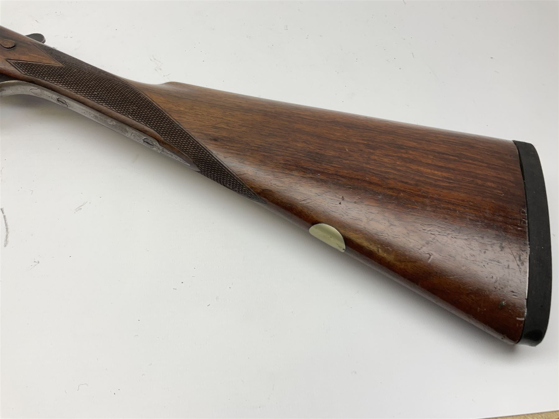 Harrods Ltd. Brompton Road London (Retailer) 12-bore side-by-side boxlock non-ejector sporting gun, 75cm barrels, walnut stock with chequered grip and fore-end and thumb safety, serial no.015, L118.5cm overall SHOTGUN CERTIFICATE REQUIRED