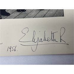 HM Queen Elizabeth II and HRH The Duke of Edinburgh - signed 1956 Christmas card with gilt embossed crown to cover, black and white photograph of the smiling Royal Couple with Prince Charles and Princess Anne on board Britannia, signed in ink 'Philip 1956 Elizabeth R',