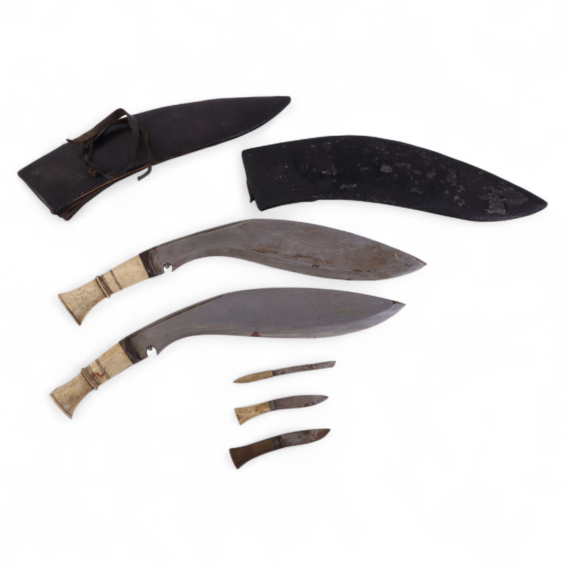 Two bone handled kukris with three small blades