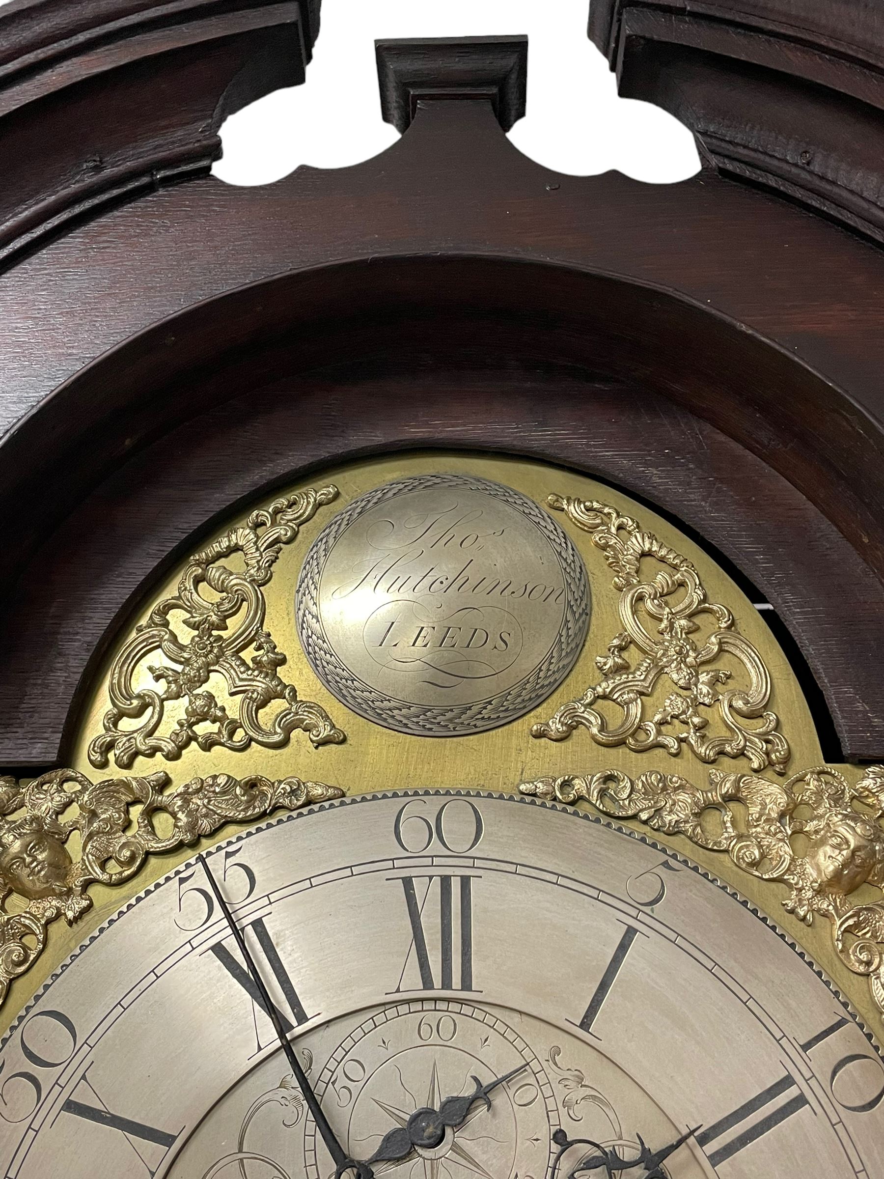 Thomas Hutchinson of Leeds - 18th century 8-day oak longcase clock with as broken arched  pediment and moulded cornice, with a conforming hood door flanked by plain turned pilasters with gesso capitals,  long trunk door with a wavy top on a square plinth with a raised panel, brass dial with cast spandrels,  engraved silvered dial centre and chapter ring with Roman numerals, five minute Arabic's and minute track, with pierced steel hands, seconds pointer,  arched calendar aperture and silvered boss engraved with the makers name to the break arch, dial pinned to a rack striking two train movement with a recoil anchor escapement. With weights and pendulum. Thomas Hutchinson is recorded as working in Leeds from 1760-90.
