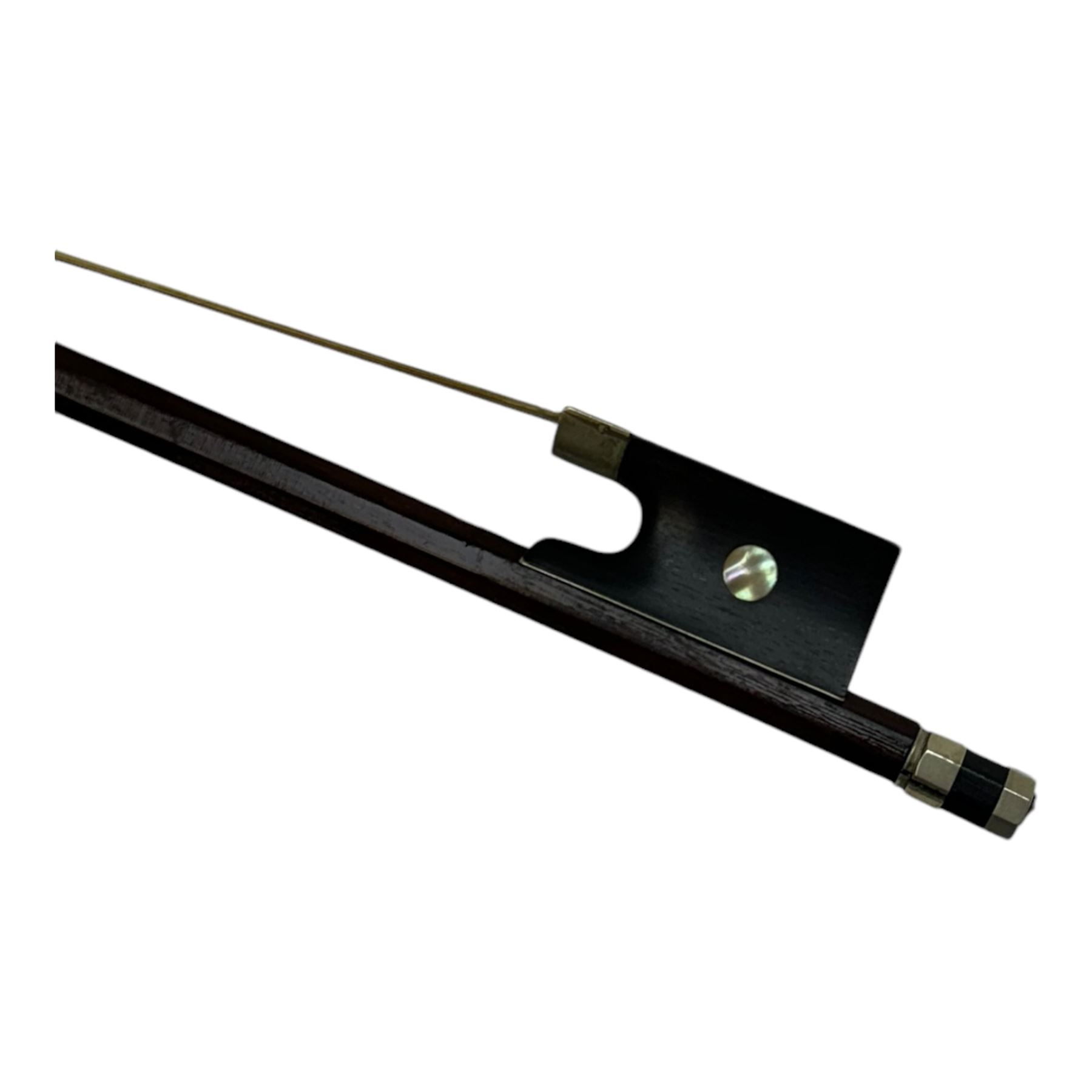 19th century full size violin in a hard case with bow. Length 60cm, scroll with ebonised pegs and fingerboard, with tailpiece and bridge.