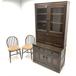 Ercol dark elm fall front cocktail display cabinet and two stick back chairs
