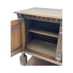 Jacobean design carved oak two door cupboard, the frieze and twin cupboard doors carved with arcaded panels and stylised foliage, raised on baluster supports united by an undertier