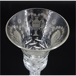 Late 18th/early 19th century drinking glass, the bell shaped part cut bowl engraved with husk swag, patera and urns, upon a single series air twist triple ring knopped stem and conical foot with ground pontil, H17cm