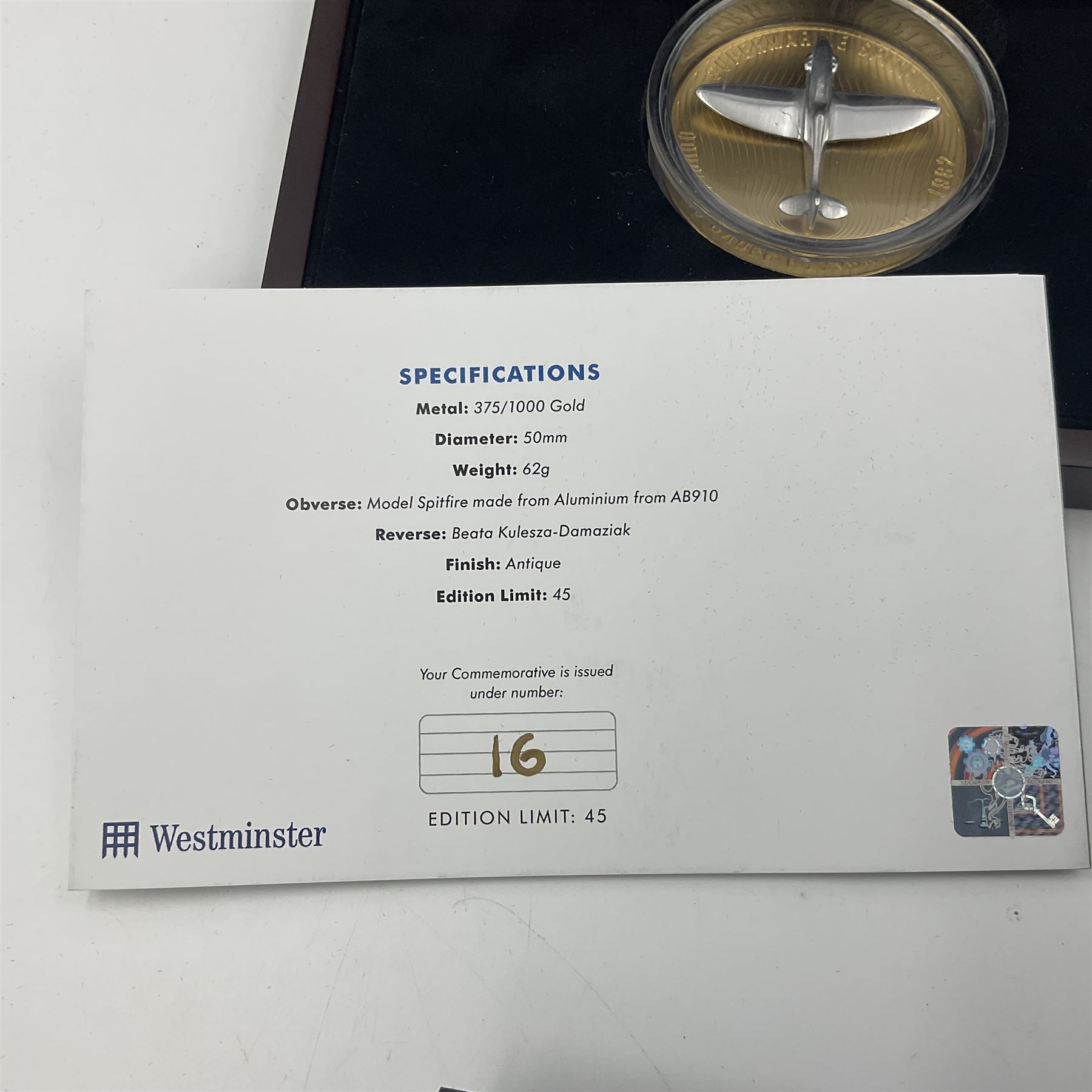 Group Captain Sir Douglas Bader gold spitfire commemorative, 9ct gold medallion mounted with a model of a Spitfire made from aluminium from AB910, gross weight 62 grams, cased with certificate