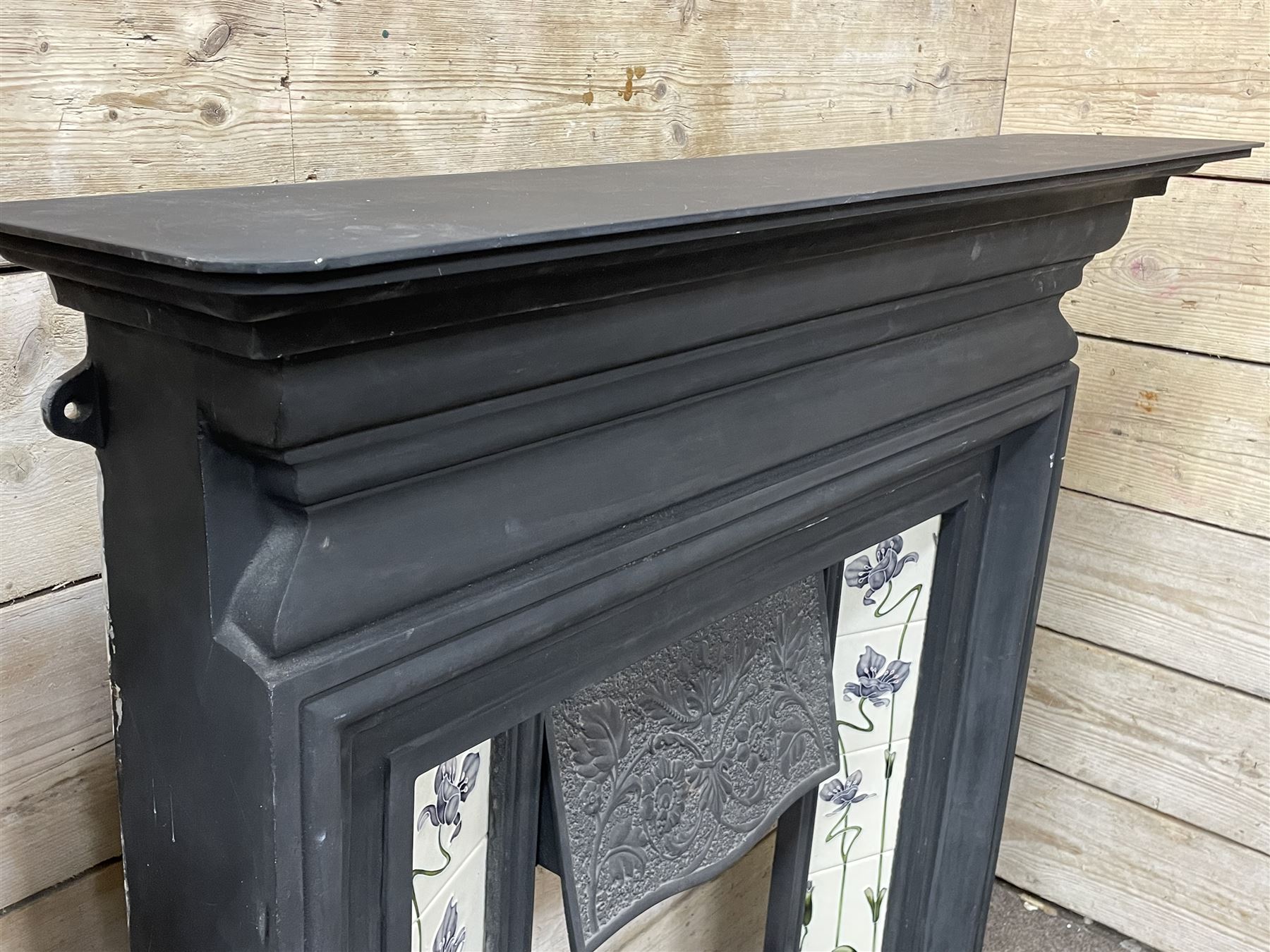 The Gallery Collection Fireplaces - 'Edwardian' cast iron fireplace, the hood decorated with interlacing floral design, with Art Nouveau inspired upright tiles