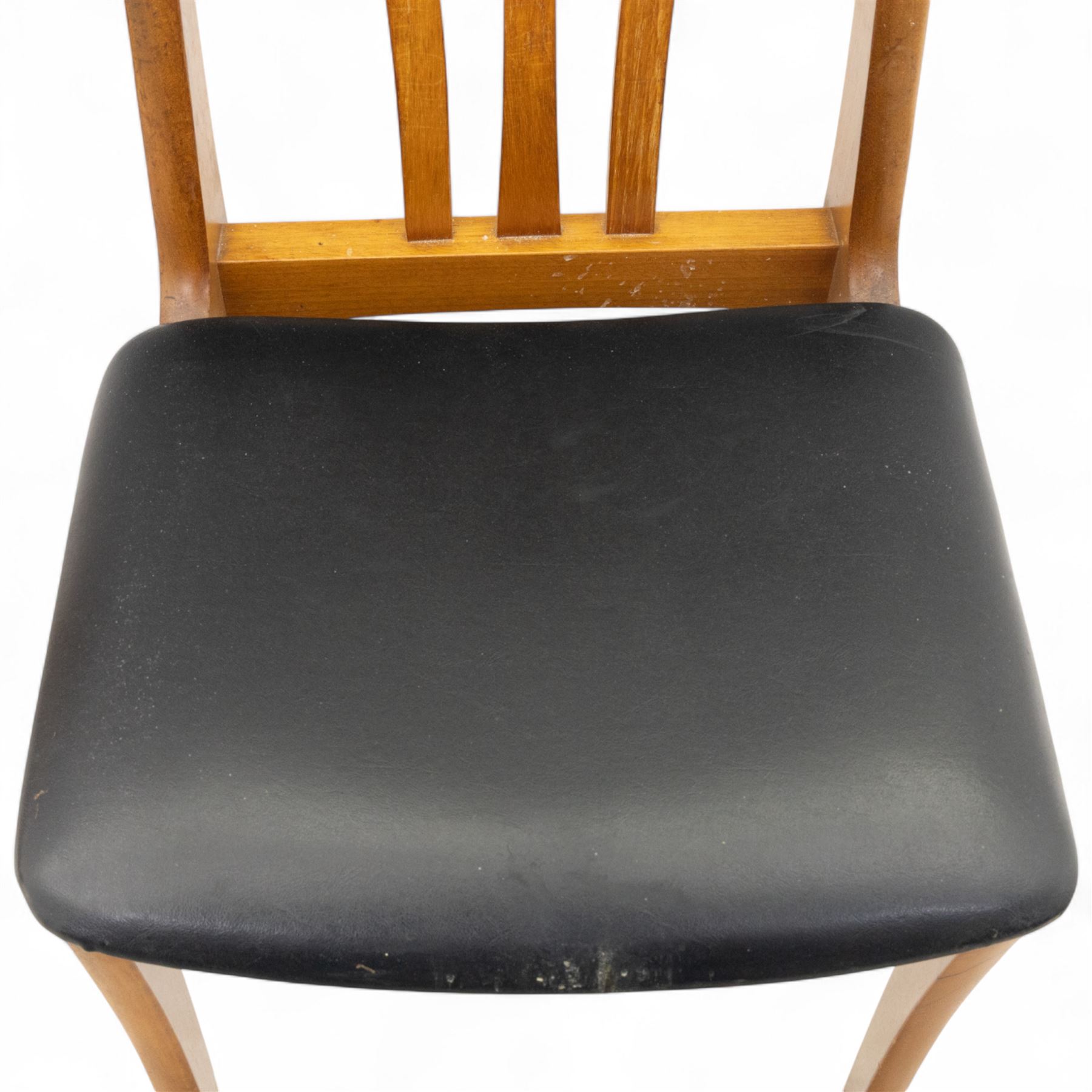 Sutcliffe of Todmorden - mid 20th century ‘S-Form’ teak dining table and chairs, the circular storable extending table with plain veneered top on tapered supports, together with matching dining chairs upholstered in black vinyl, with curved slat backs and shaped front supports, reflecting the sleek organic styling characteristic of 1960s British modern furniture design (Chairs H 93cm, W 46cm, D 46cm) (Extended 168cm)