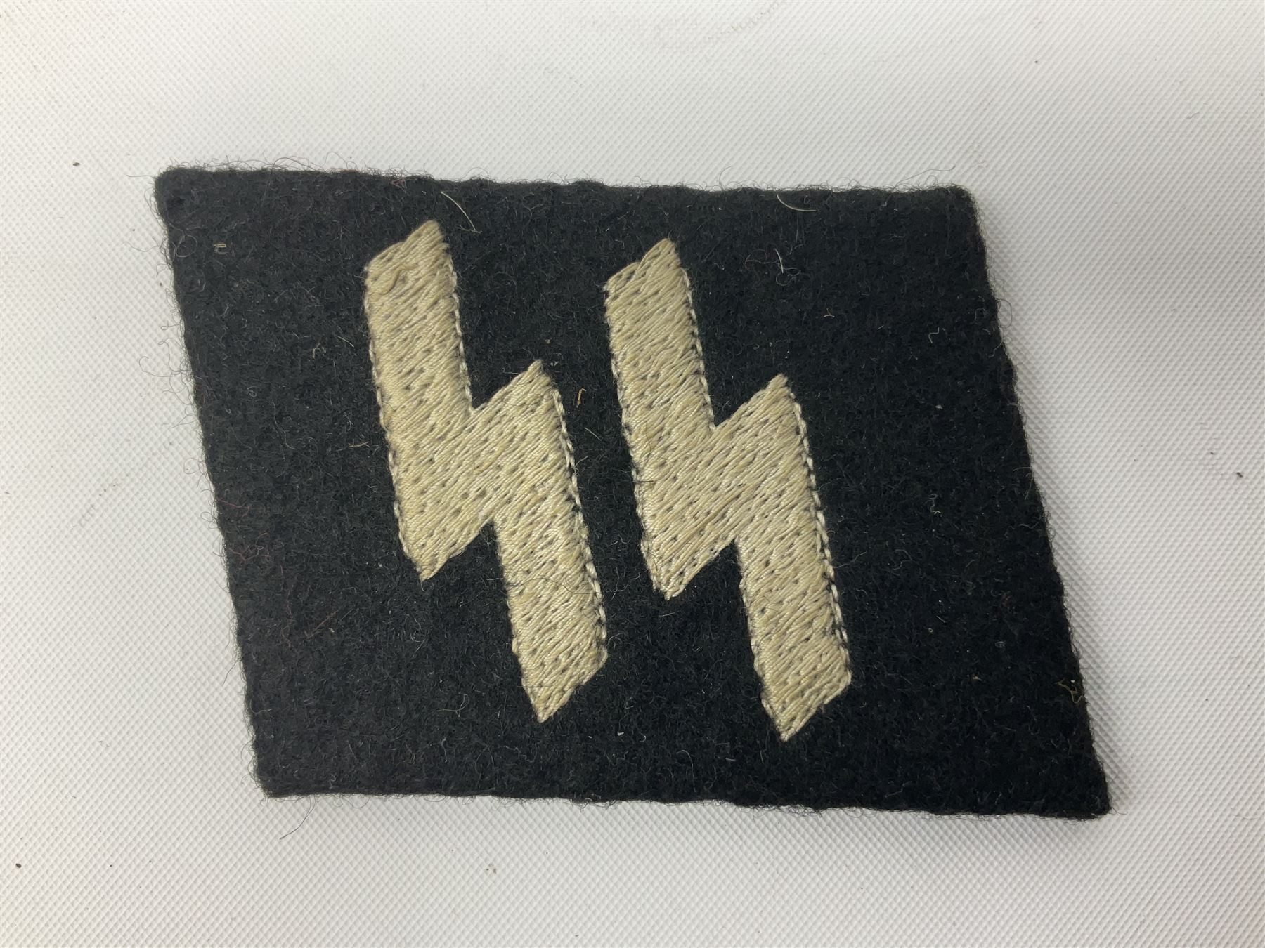 Two WW2 German 'SS' uniform cloth collar patches and sleeve eagle for Schafuhrer rank (3)