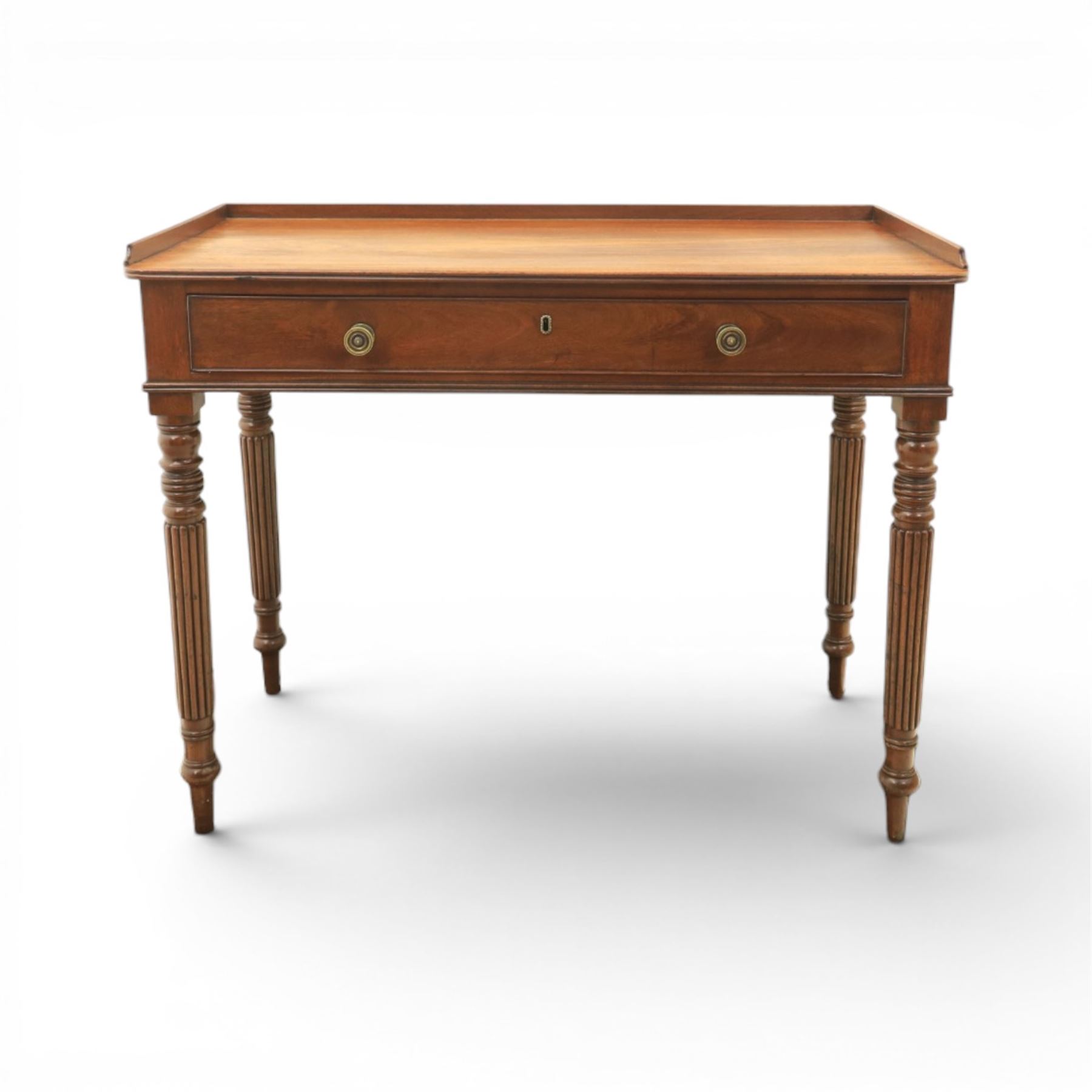 Early 19th century mahogany dressing table, rectangular top with three quarter gallery, frieze drawer with two brass knobs, stamped 'Gillow', raised on turned and reeded supports 