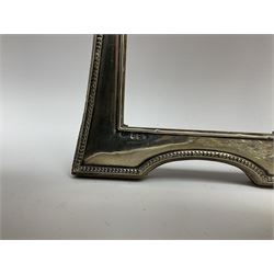 Clear glass decanter of slender oviform with silver collar stamped MN & WB 925, Mappin & Webb, together with an early 20th century silver photo frame hallmarked G & C Ltd of Birmingham, two clear glass shakers with pierced silver tops and silver collared glass storm lampshade with etched decoration, tallest H37.5cm