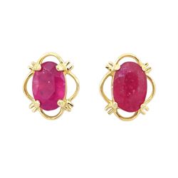 Pair of 9ct gold oval cut ruby stud earrings, stamped
