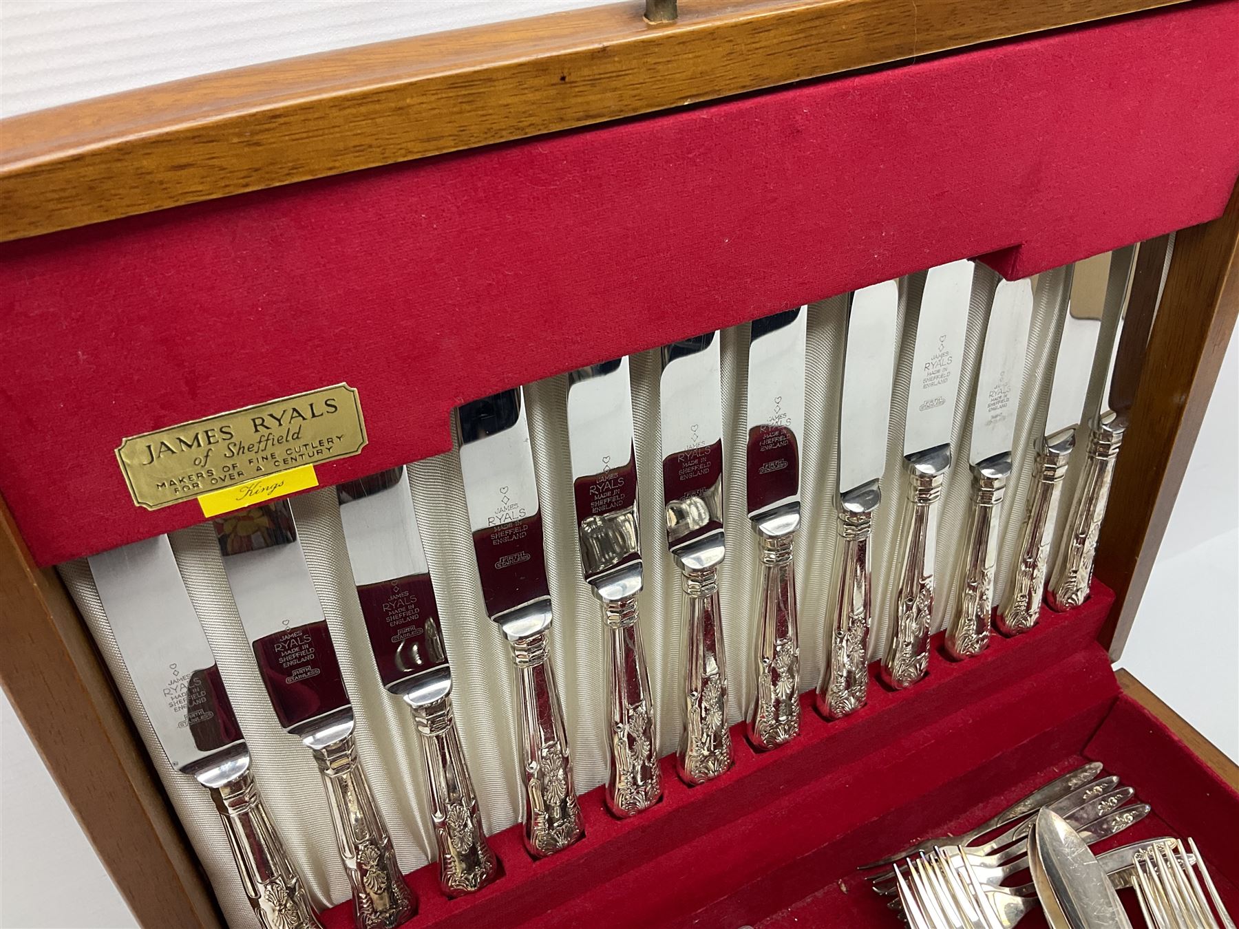 Canteen of King's pattern cutlery for six place settings by James Ryals of Sheffield, with two extra forks, pair of salad servers and six fish knives, all within fitted wooden case, together with six ivorine handled butter knives and six silver plated cake forks