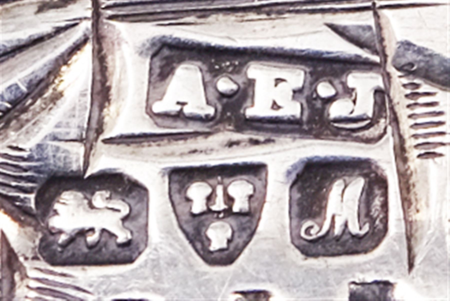 Five early 20th century silver stamp holders modelled in the form of envelopes, comprising three foliate engraved examples, and two plain examples, one with applied detail 'Stamps' verso, hallmarked Albert Ernest Jenkins, (makers mark to one example worn and indistinct),  Chester 1904, 1906, 1908 and 1912, approximate total weight 0.60 ozt (18.6 grams)