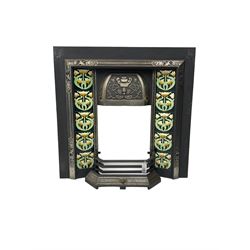 Victorian design cast iron fire inset, the hood with floral decoration, fitted with floral upright tiles