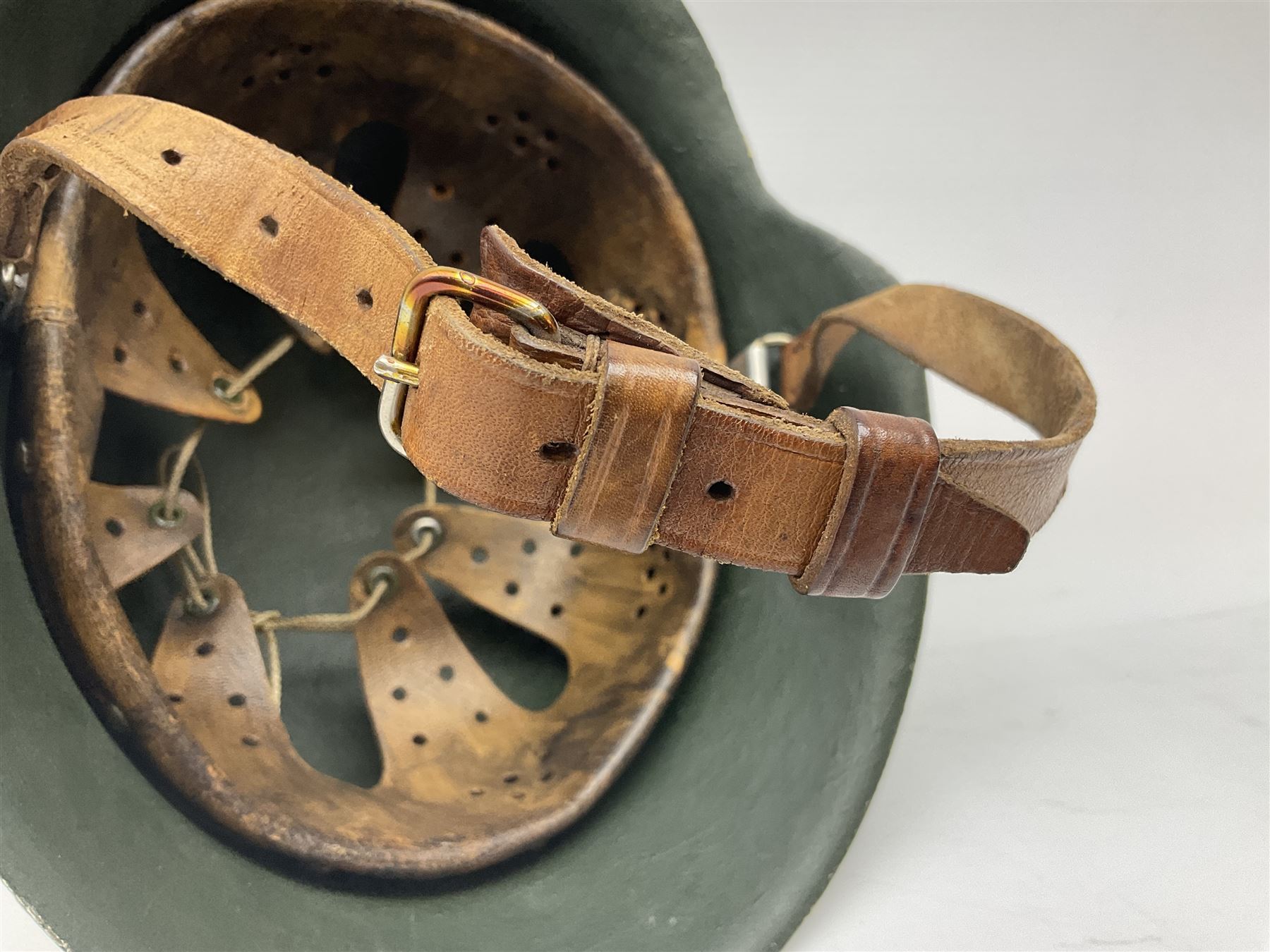 Fully restored German steel helmet, the camouflage painted exterior with two decals and replacement leather liner