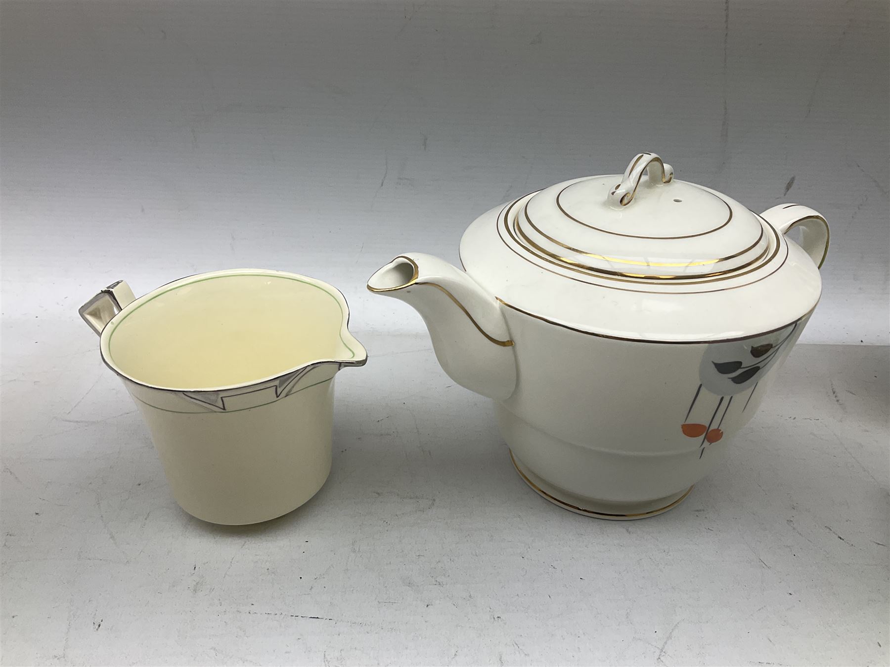 Art Deco style tea service by Alfred Meakin in Marigold pattern, comprising four cups and saucers, six dessert plates, one side plate, milk jug and sugar bowl, together with an art deco teapot, Royal Winton wares etc 