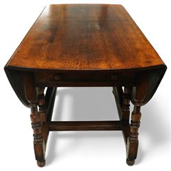 Large 18th century design oak drop-leaf dining table, oval top with twin hinged drop leaves, drawers to either end, raised on turned supports united by an H-stretcher base
