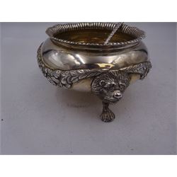 Early 20th century silver open sucrier, of circular form, with fluted gadrooned rim and decorated in relief with floral swags, united by three lion mask mounts and upon three paw feet, hallmarked Z Barraclough & Sons, London 1912, H6cm, D11cm, with similar spoon with lion mask finial, hallmarked London 1912, maker's mark indistinct