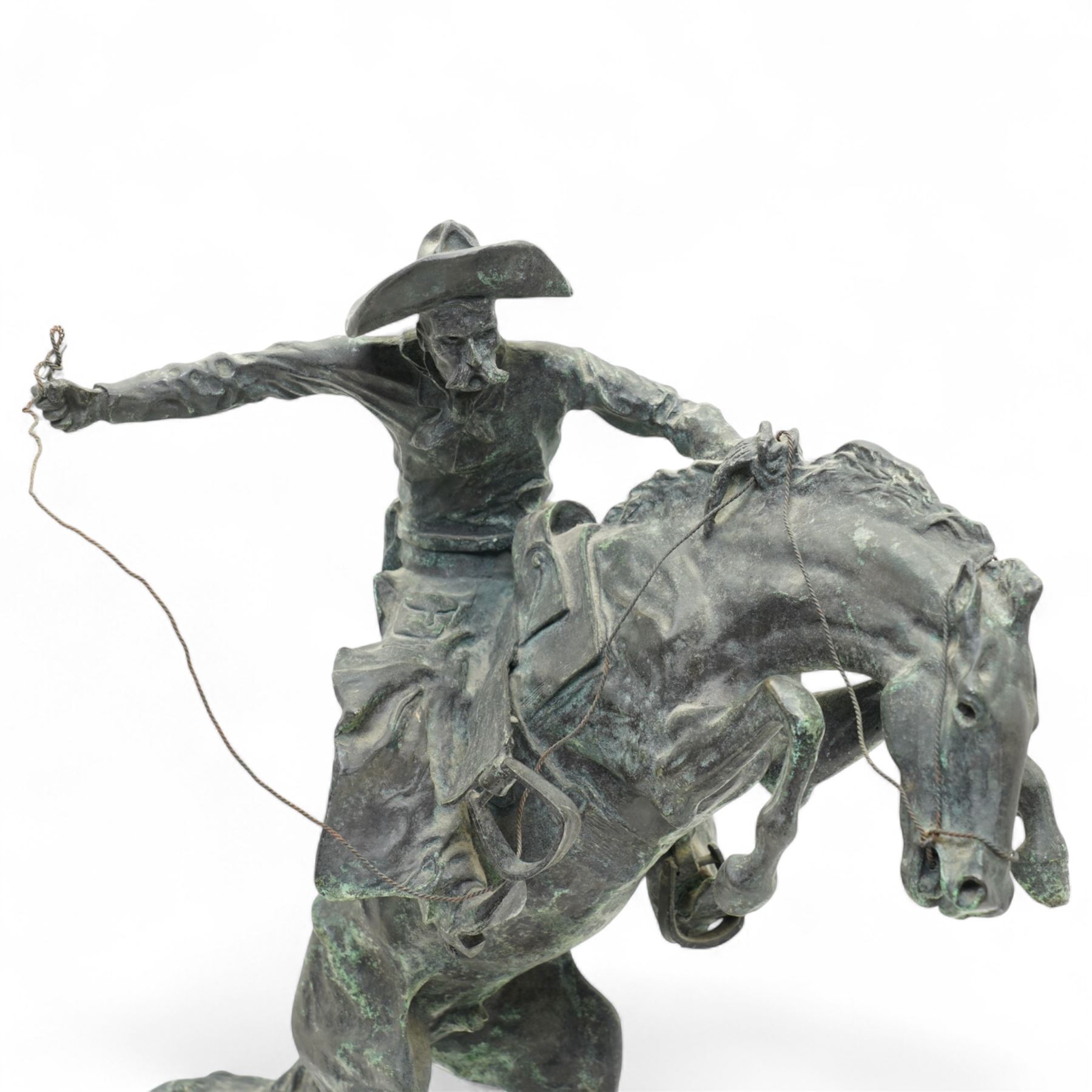 After Frederick Remington (American 1861-1909): 'Bronco Buster', limited edition bronze bearing signature and numbered 7/100, with foundry or ranch mark to horses backside of a triangle within circle, on green marble base, H56cm