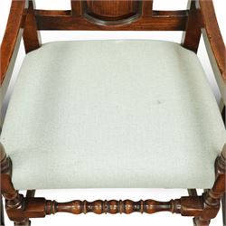 Country House oak high back dining chairs, set of ten comprising eight side chairs and two carvers, each with arched top rail flanked by turned finials over a central fielded panel back, with overstuffed seats upholstered in pale fabric, raised on turned front supports united by stretchers