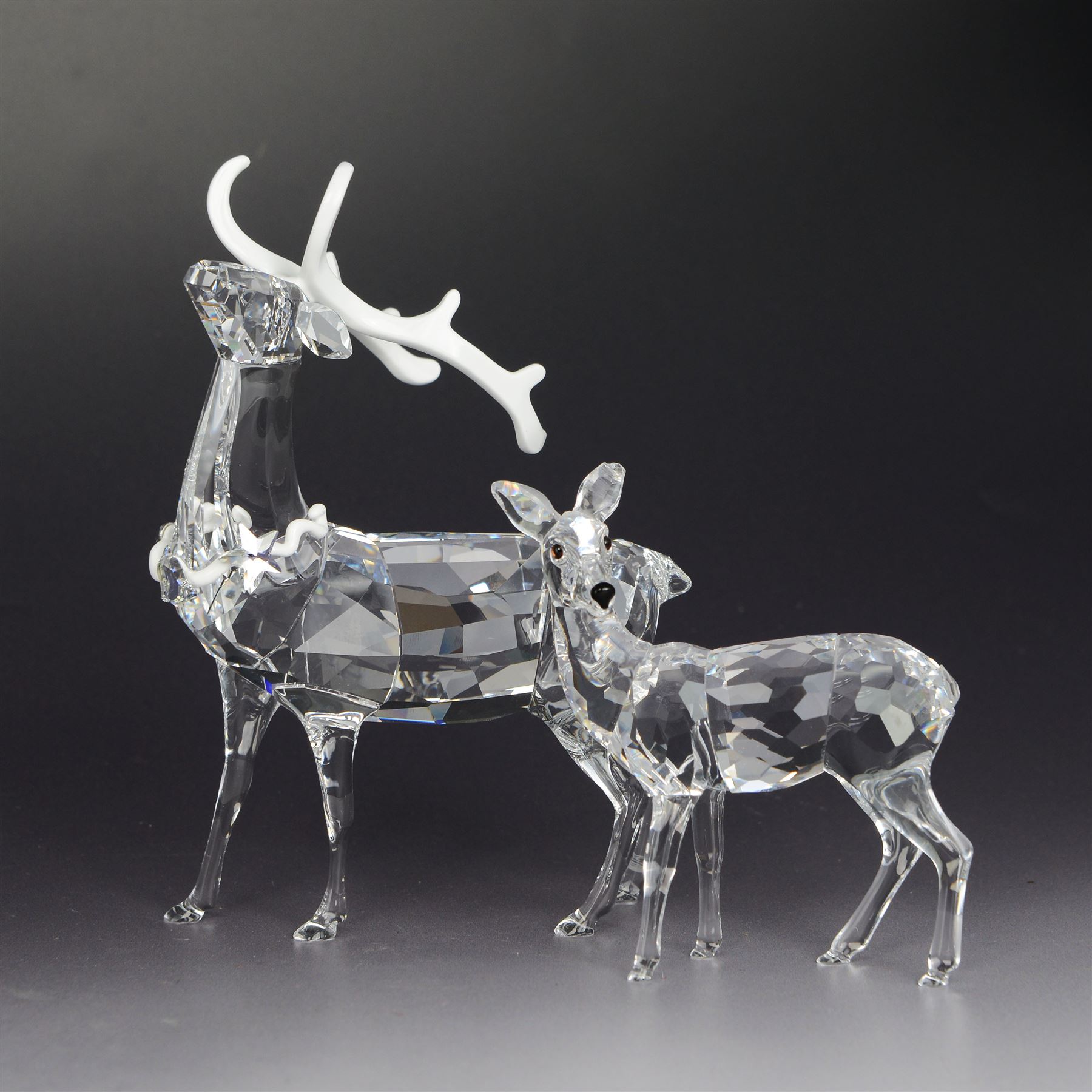 Two Swarovski figures, comprising Doe and Christmas Stag, both in original boxes 