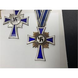 WWII set of three German Mother's Crosses, 1st Class in gilt, 2nd Class in silver and 3rd Class in bronze; all with ribbons (3)