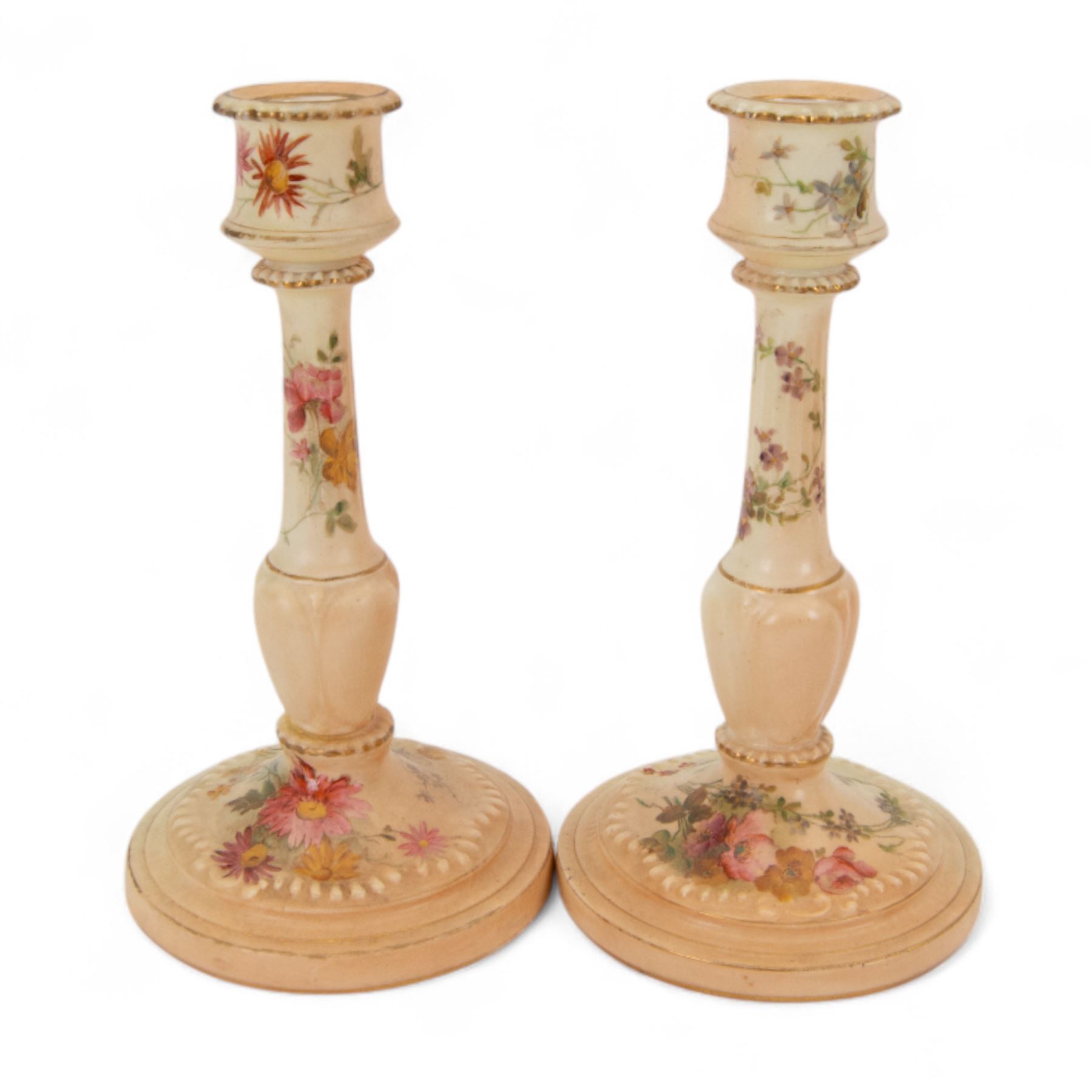 Royal Worcester blush ivory dressing table set, decorated with flowers, comprising an oval tray, three covered pots and a pair of candlesticks 