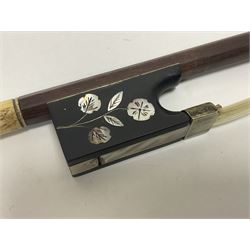 19th century wooden violin bow with a decorative mother of pearl inlay depicting flowers to the frog, with a bone adjuster screw