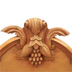 Victorian pine chiffonier, shaped moulded top with raised scroll carved back surmounted by carved fruit and foliate crest, fitted with two frieze drawers over two panelled cupboard doors, the outer cupboards of bowed form, carved foliate corbels, on plinth base