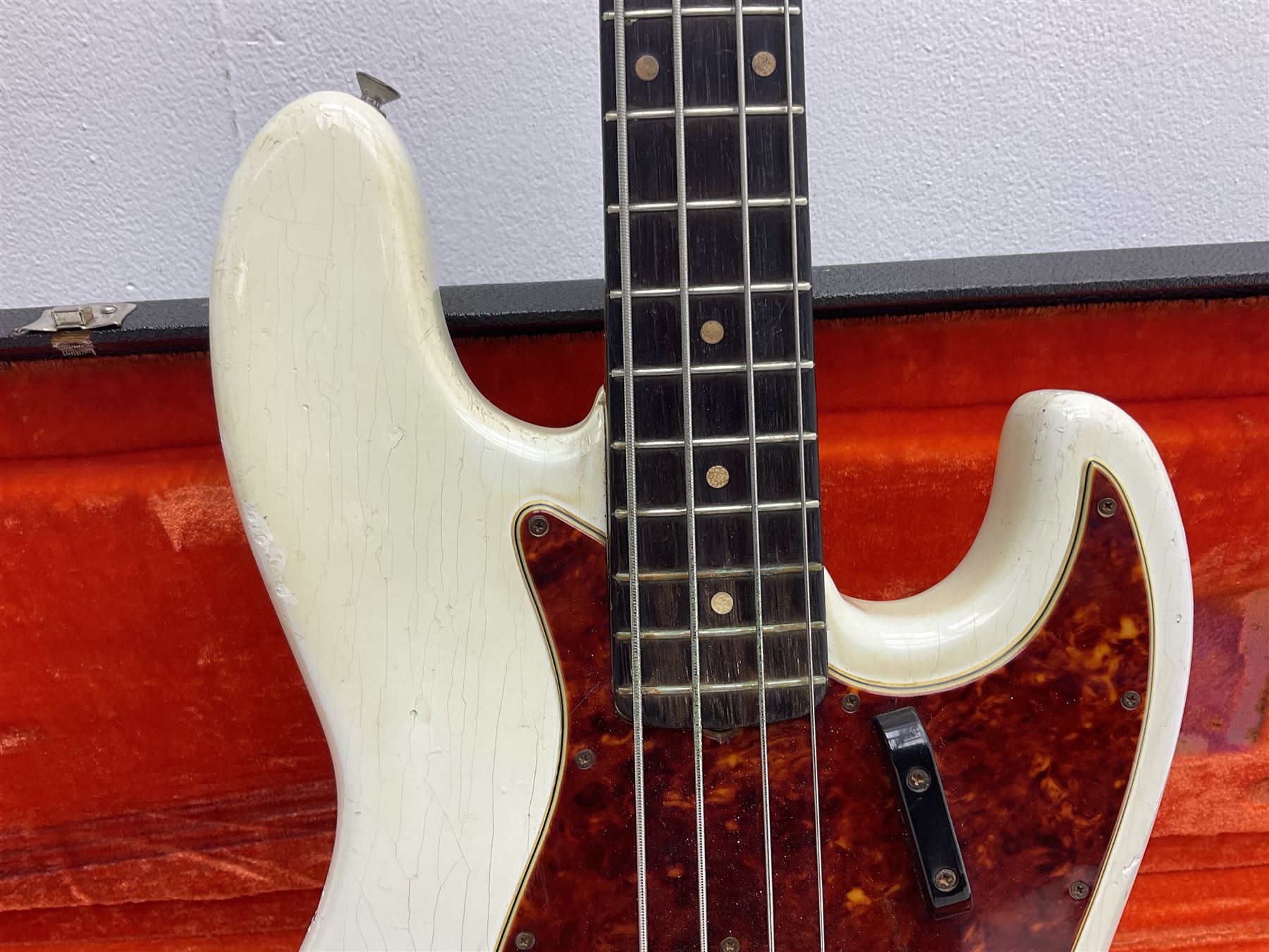 1963 Fender Jazz three-knob bass guitar; impressed with date code 7AUG63A on end of neck and serial no.L08587 on back plate; all original but re-finished in white in the 1970s; sold with photographs of the instrument in the 1960s with original finish and in the 1970s re-finished; L117.5cm; in original hard carrying case; Provenance: the professional guitar of Howard Livett from new to his death in 2005. Howard played in The Humperdincks, the backing group for Englebert Humperdinck, also played in the backing group for Max Bygraves and in the band Hedgehoppers Anonymous. The guitar is also sold with a manuscript letter of provenance from Howard's wife.
