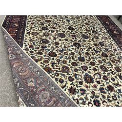 Kashan beige ground rug, trailing foliage field, red border with repeating pattern