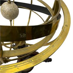 19th century brass terrestrial armillary sphere on rosewood base, lobe carved column on three splayed supports with scrolled carved terminals, the supports united by circular compass with turned stretchers