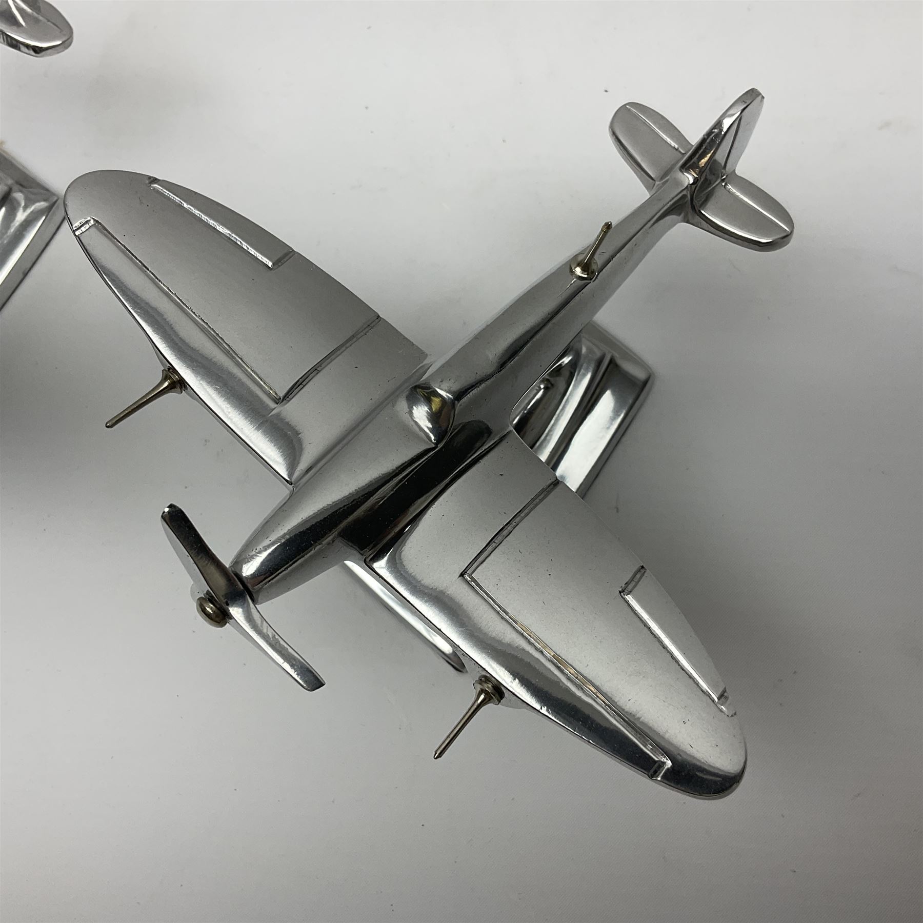 Set of three aluminium planes with rotating propellers, tallest H18cm